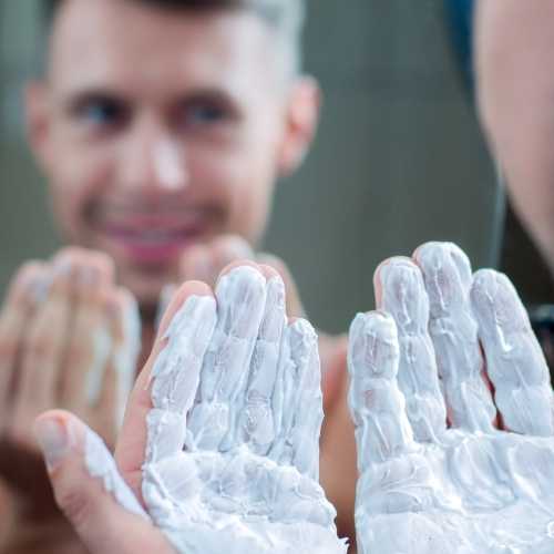 man with shaving foam on his hands