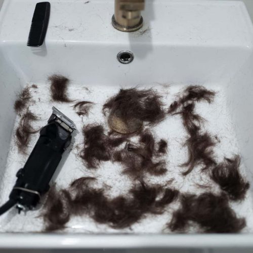 Removing hairs from hair clippers