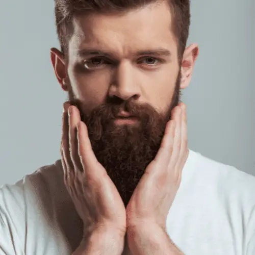 ginger haired man with long beard after he applied beard butter